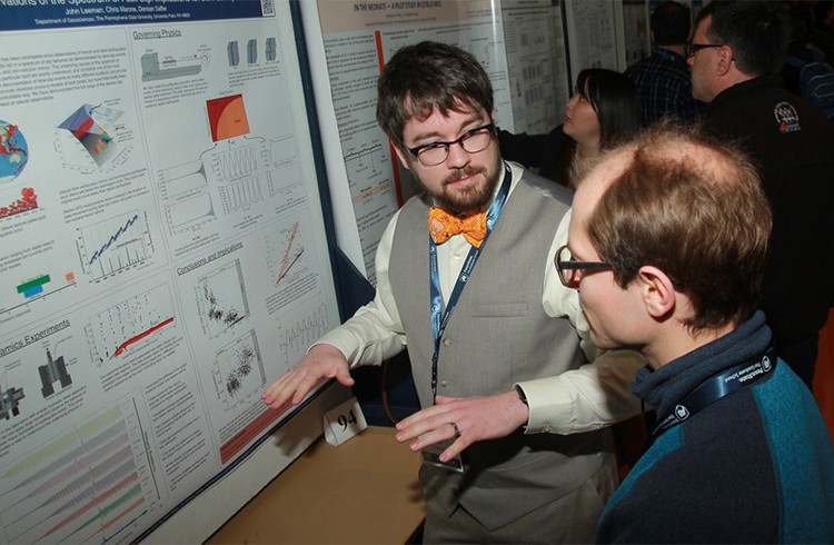 Student explaining research poster