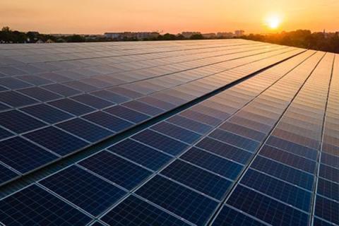 Solar panels reflect orange from the setting sun 