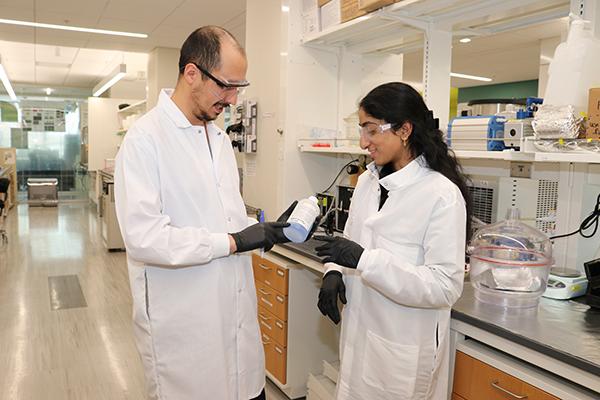 2024 My Green Lab Consultants Zaman Ataie and Ananya Gollakota check the expiration date on a chemical bottle